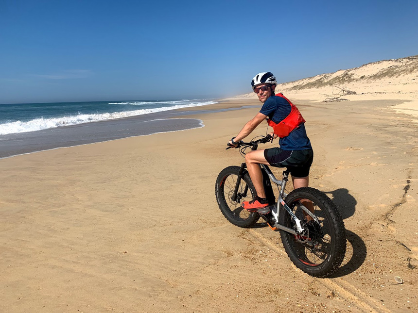 Paul en vélo sur une plage des Landes